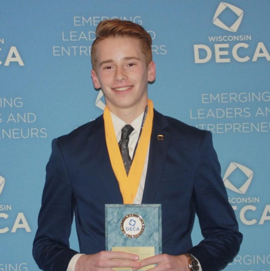 Sawyer Sullivan (grade 12) pictured with his DECA award. 