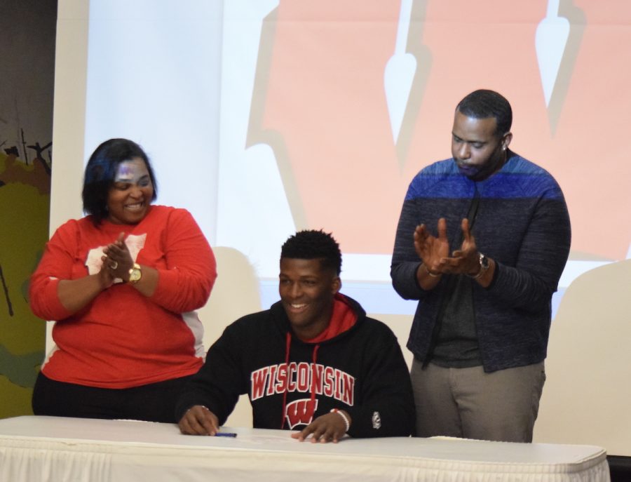 Keanus parents join him at the signing table. Keanus face lit up when Coach (Paul) Cryst offered him a full ride scholarship, said athletic director Ben McCormick.