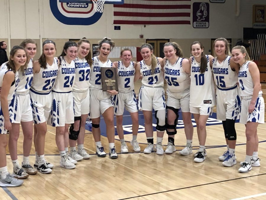 The Cougars pose with the regional championship plaque after defeating Sun Prairie 40-37 on Saturday, Feb. 29, 2020. They advance to the sectional and will play #1 ranked Middleton on Thursday, March 5, at Beloit Memorial.