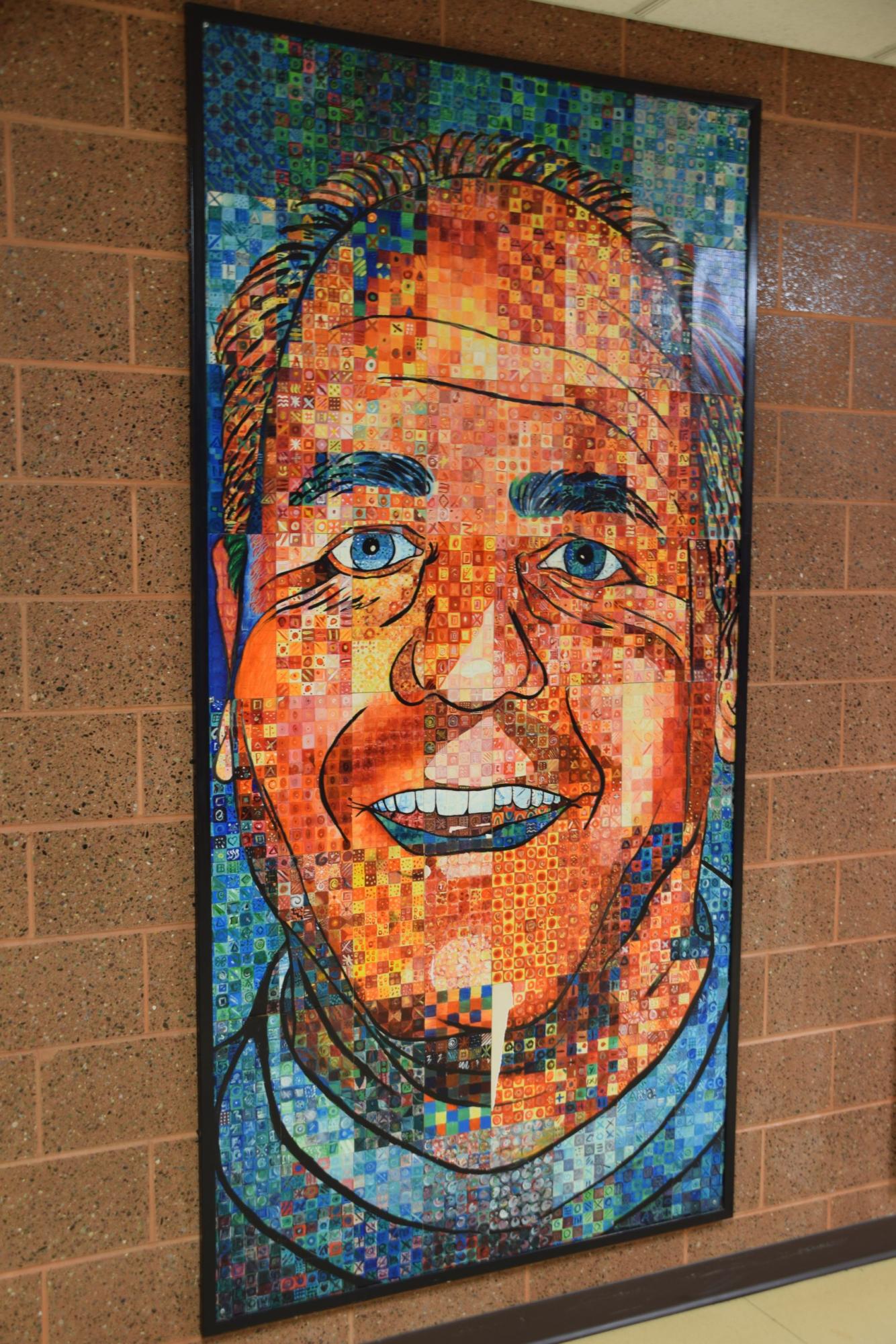 This mosaic painting of Dr. Kuehne hangs in the hallway outside of the field house.